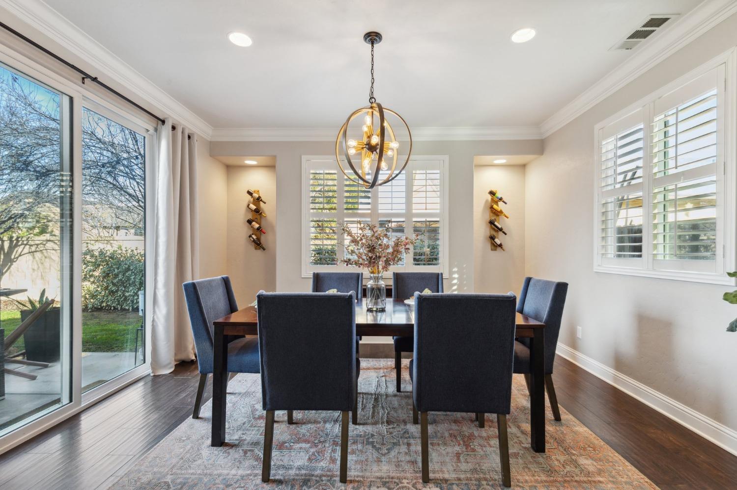 4217 Salem Lane Clovis, CA 93619 - Photo 14 of 57 a view of a dining room with furniture large windows and wooden floor