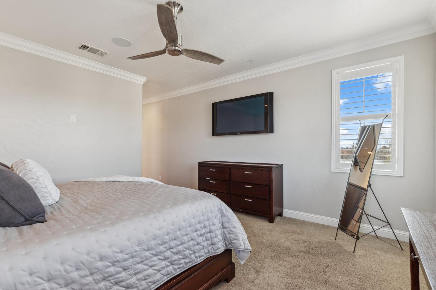 4217 Salem Lane Clovis, CA 93619 - Photo 20 of 57 a bedroom with a bed and a flat screen tv