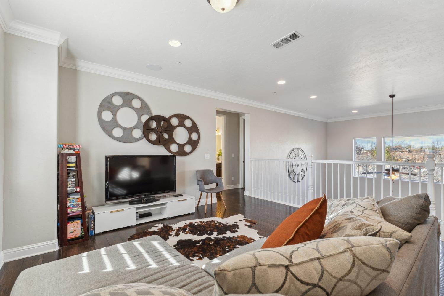 4217 Salem Lane Clovis, CA 93619 - Photo 24 of 57 a living room with furniture a flat screen tv and a fireplace