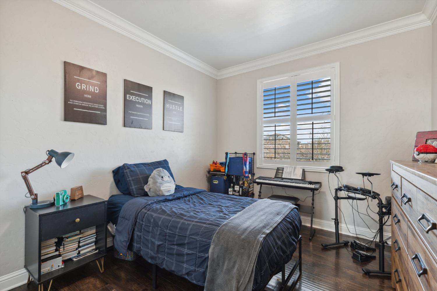 4217 Salem Lane Clovis, CA 93619 - Photo 29 of 57 a bedroom with a bed and wooden floor