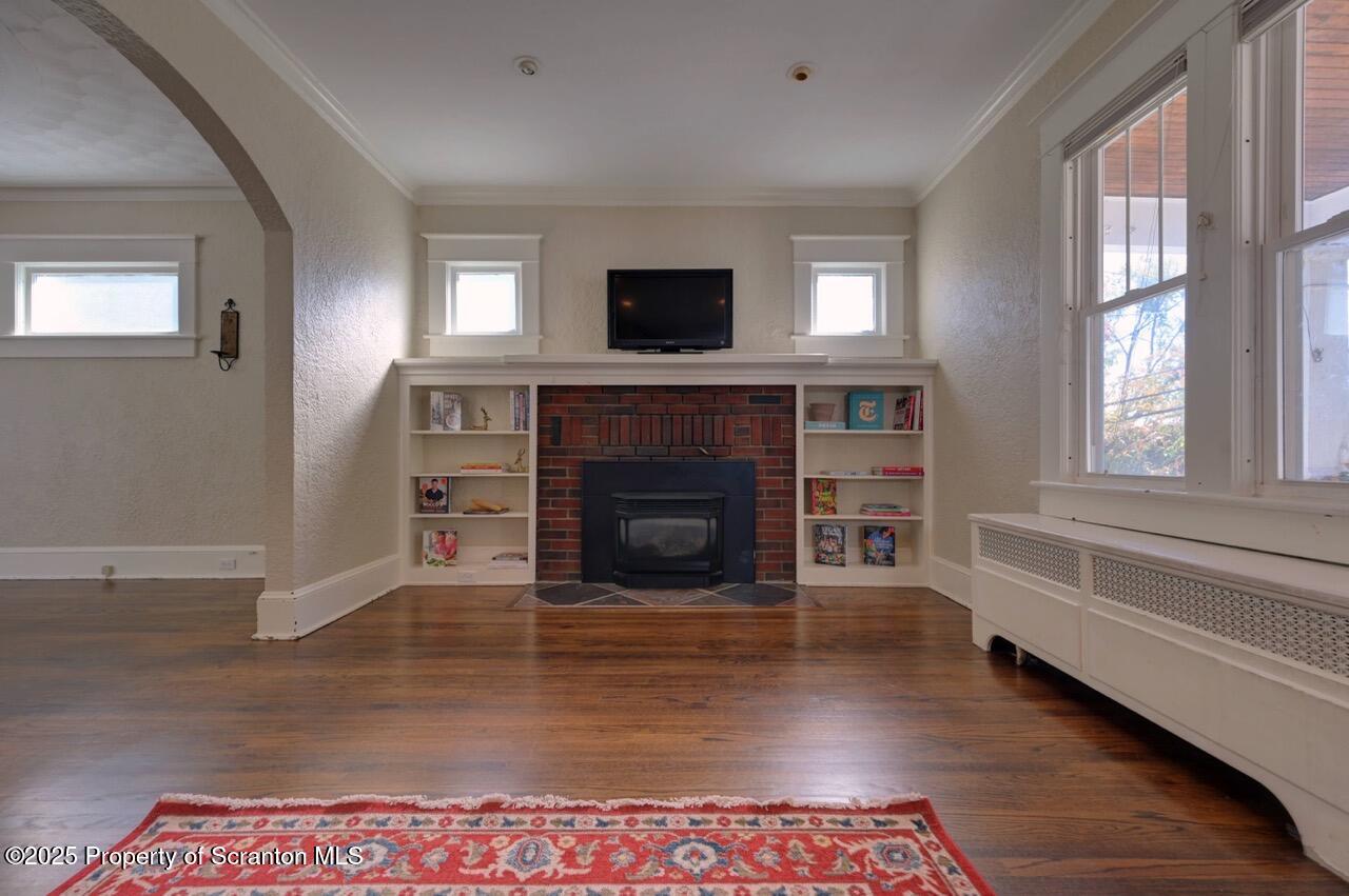 120 Glenburn Road Clarks Green, PA 18411 - Photo 11 of 34 a living room with a fireplace and a flat screen tv