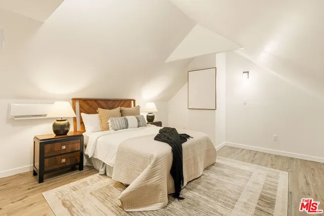 a bedroom with a bed and a night stand