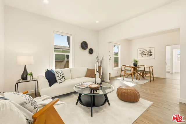 a living room with furniture a rug and a large window