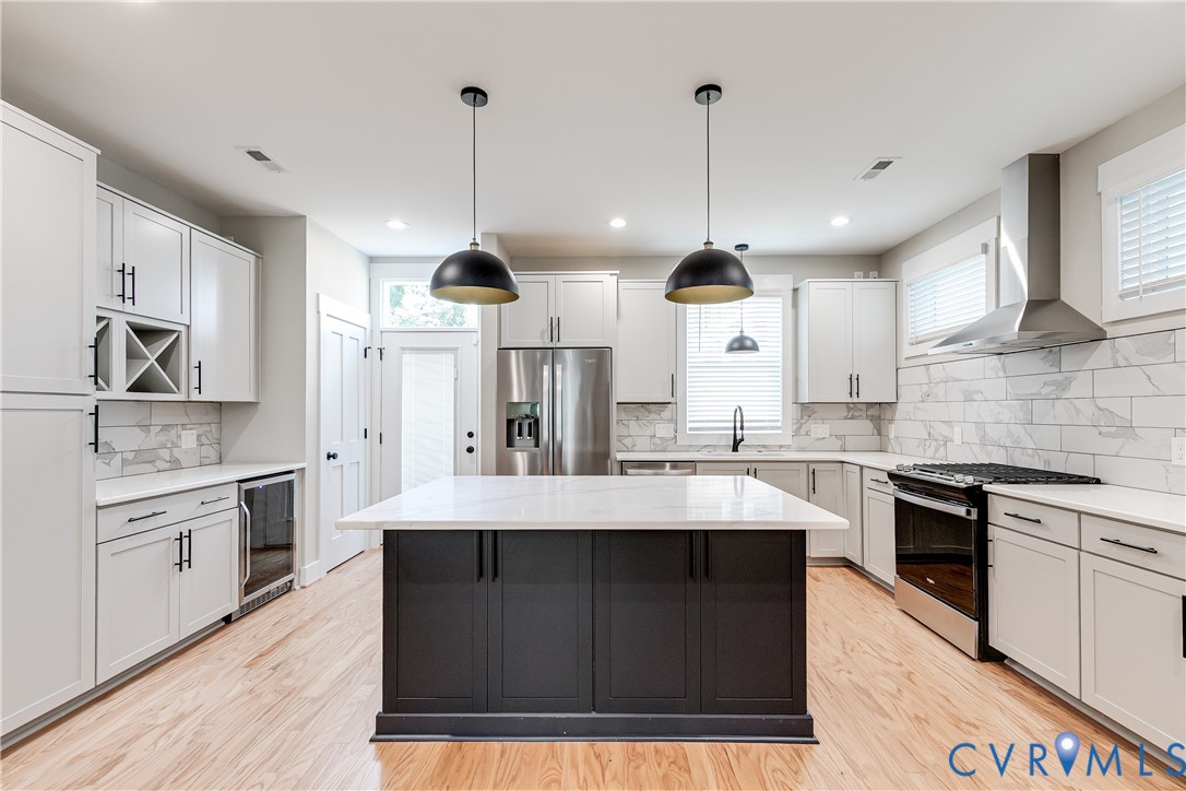2917 R Street Richmond, VA 23223 - Photo 8 of 35 Kitchen with stainless steel appliances, hanging l