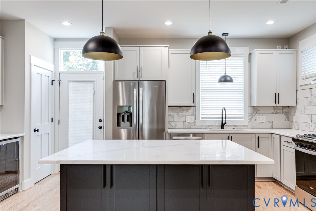 2917 R Street Richmond, VA 23223 - Photo 9 of 35 Kitchen with light wood-style flooring, beverage c