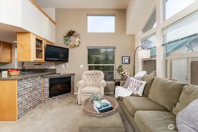 a living room with furniture flat screen tv and large window