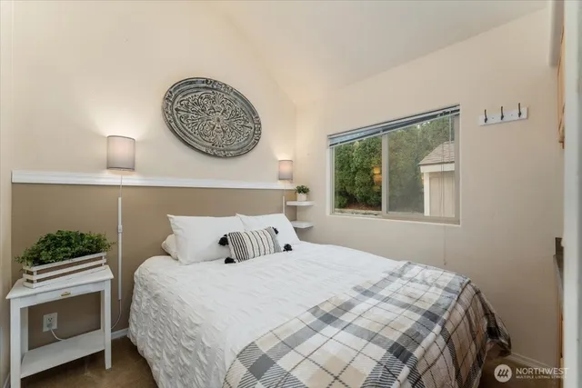 a bedroom with a bed and a painting on the wall