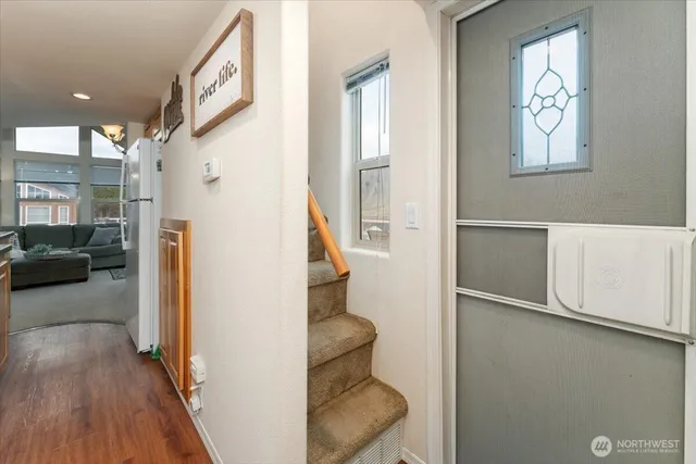 a view of entryway and hall with wooden floor