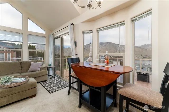 a dining room with furniture and a large window
