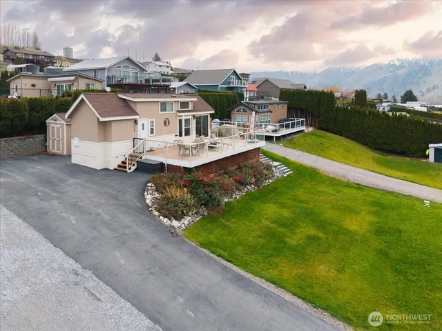 an aerial view of a house with swimming pool garden and lake view