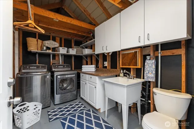 a kitchen with a sink appliances and cabinets