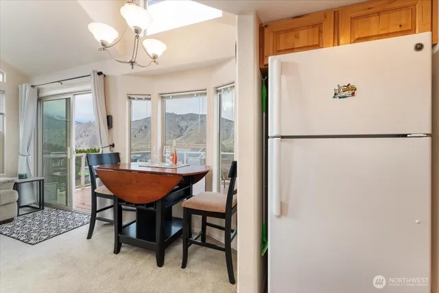 a view of a dining room with furniture and a chandelier