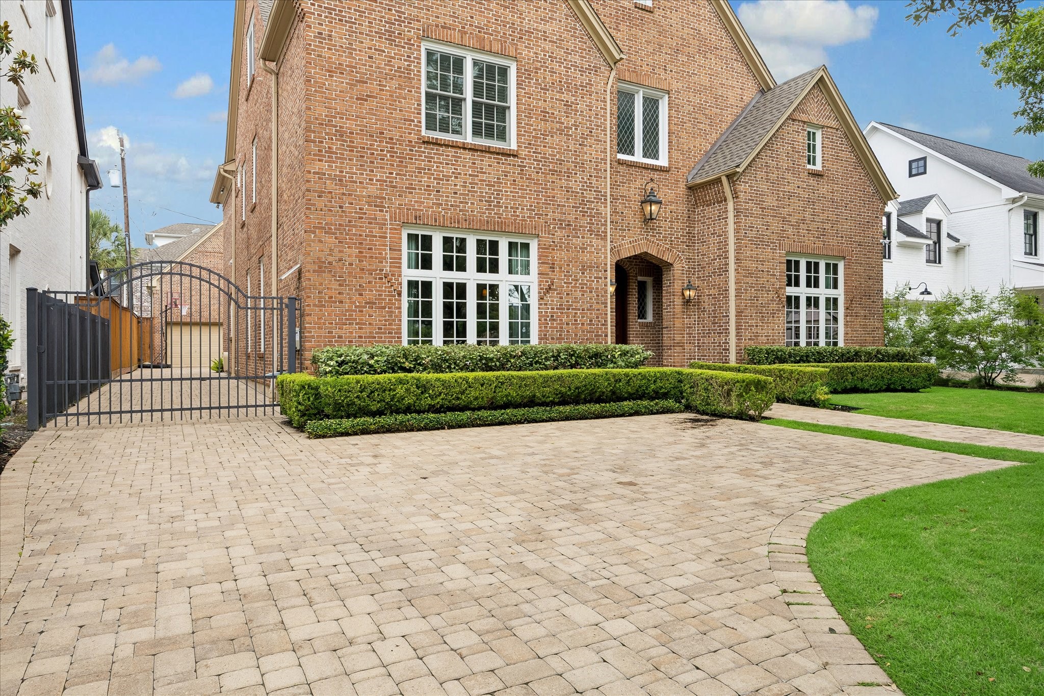 6358 Auden Street Houston, TX 77005 - Photo 47 of 50 a front view of a house with a yard and a garage