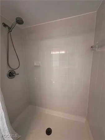 a bathroom with a granite countertop toilet sink and mirror