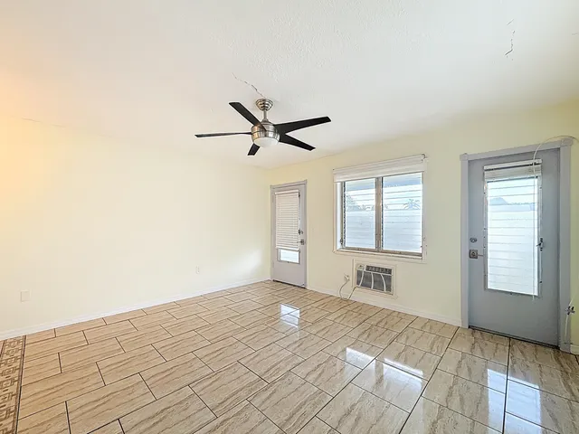 a view of a livingroom with a ceiling fan and window