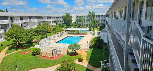 a view of a house with backyard outdoor seating and hardwood