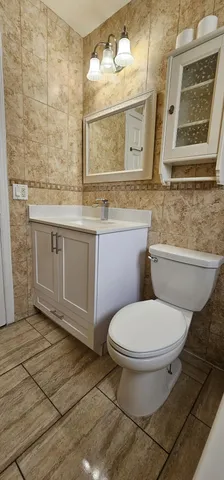 a bathroom with a toilet sink and mirror