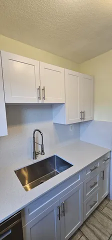 a kitchen with a sink cabinets and appliances