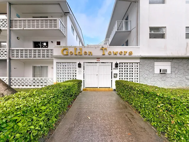 a front view of a building with a garden