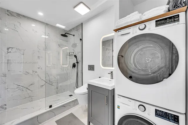 a bathroom with a toilet sink shower and mirror