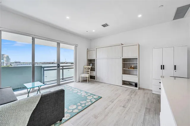 a living room with a large window and a table chair