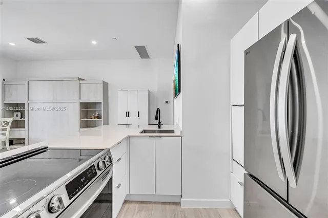 a kitchen with a stove a sink and a refrigerator