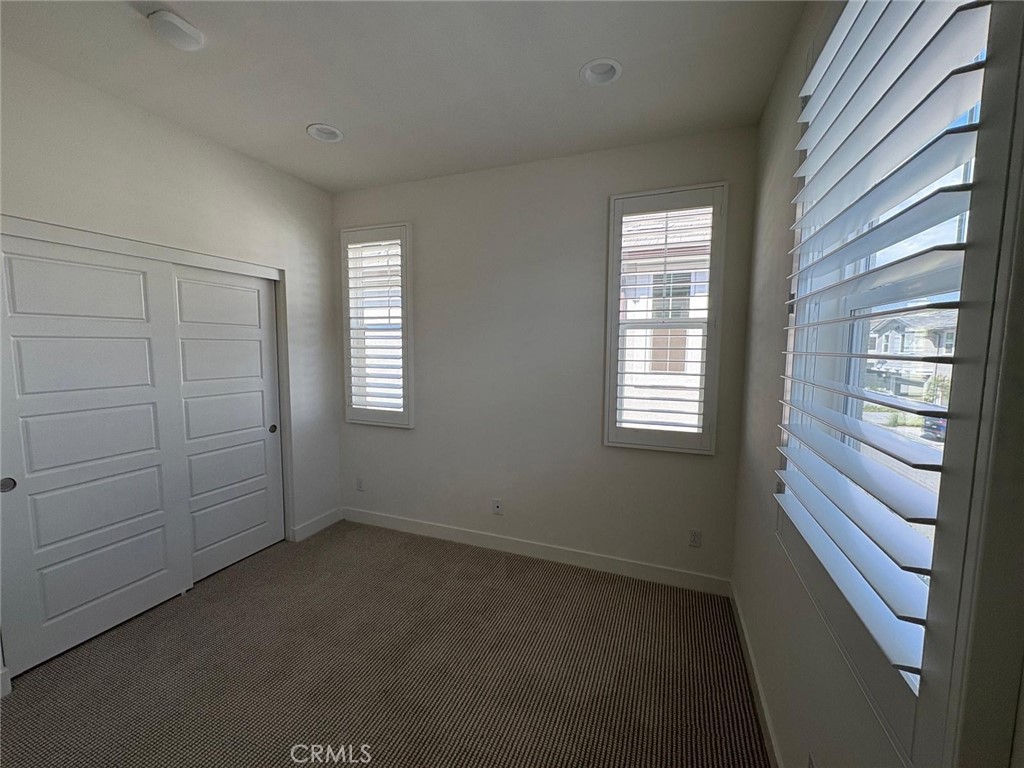 4252 East Sage Paseo, Unit 132 Ontario, CA 91761 - Photo 3 of 7 an empty room with windows