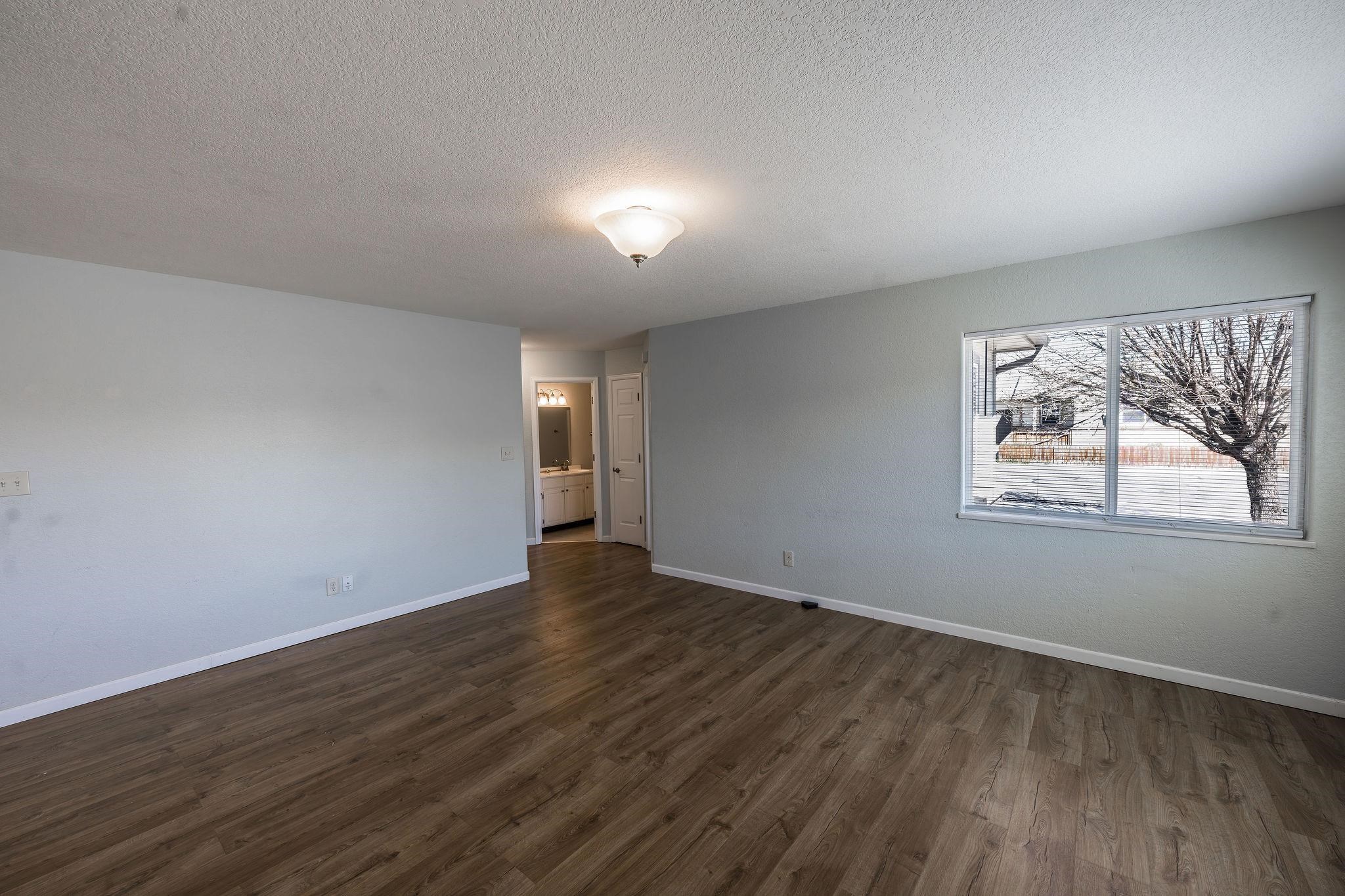 455 David Court Fruita, CO 81521 - Photo 2 of 28 a view of an empty room with wooden floor and a window