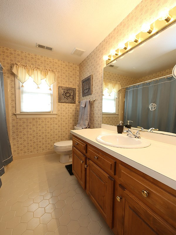 2009 Hamrick Drive Raleigh, NC 27615 - Photo 17 of 25 Ceramic Tile Floor, Shower Combo, Single Sink Guest Bathroom