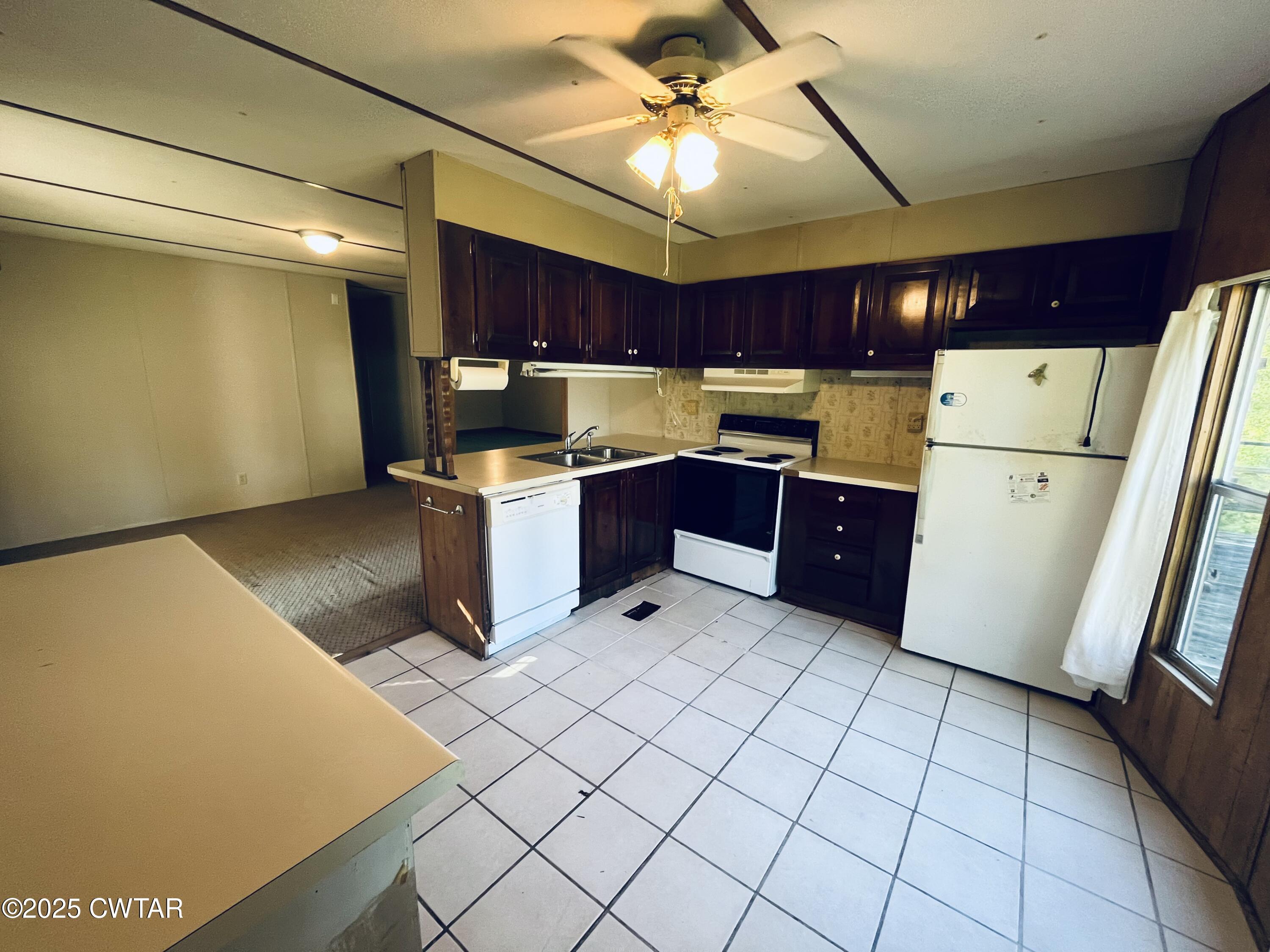 294 Ridgeway Road Sugar Tree, TN 38380 - Photo 24 of 34 a kitchen with a cabinets and white appliances