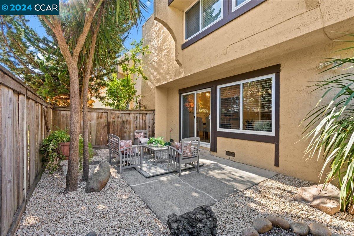a backyard of a house with yard and outdoor seating
