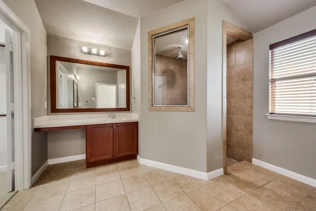 a view of a mirror and cabinets