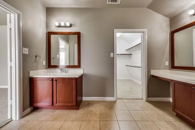 hallway with granite countertop and mirror