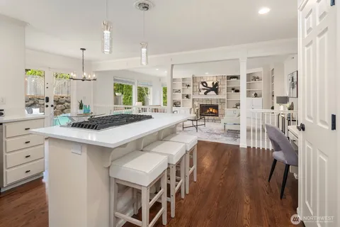 a large kitchen with cabinets table and chairs