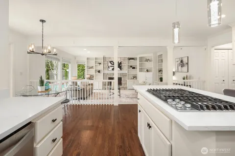 a kitchen with stainless steel appliances granite countertop a stove and a wooden floors