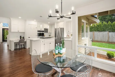 a dining room with furniture and wooden floor