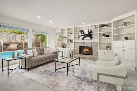 a living room with furniture a window and a fireplace