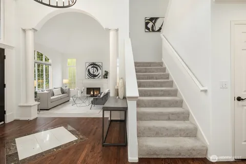 a view of entryway and hall with wooden floor