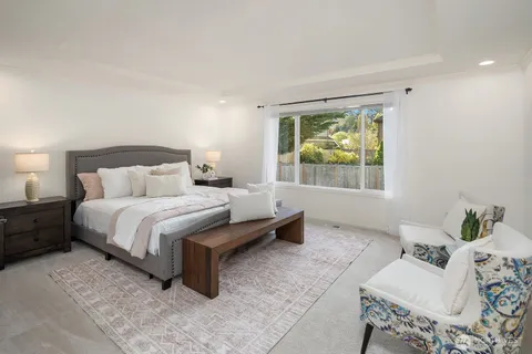 a bedroom with a bed and window
