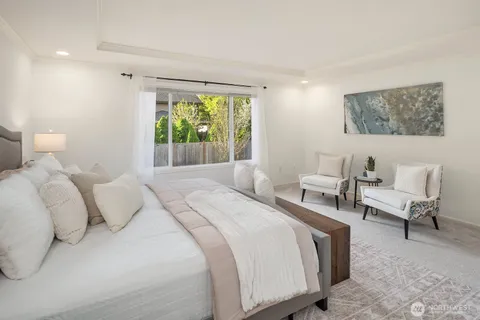 a bedroom with bed and a large window
