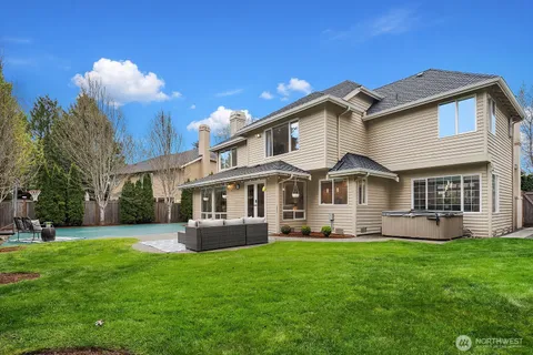 a front view of a house with a yard and trees