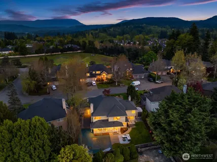 an aerial view of a house with garden space lake view and mountain view