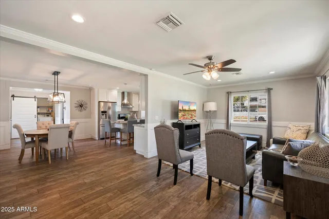 a view of a dining room with furniture and wooden floor