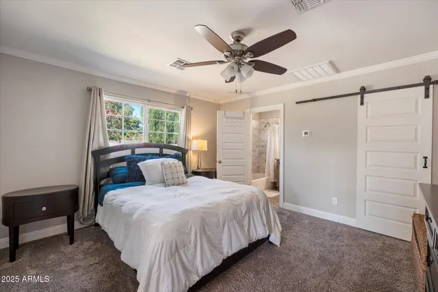 a bedroom with a large bed and a chandelier