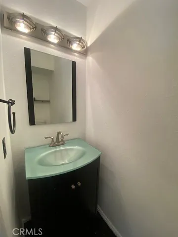 a bathroom with a sink vanity and a mirror
