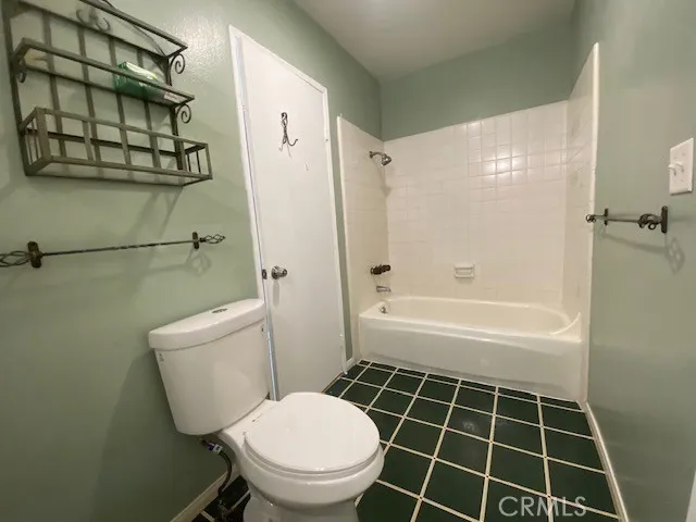 a bathroom with a toilet a sink and shower