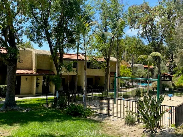a swimming pool with an outdoor space and seating area