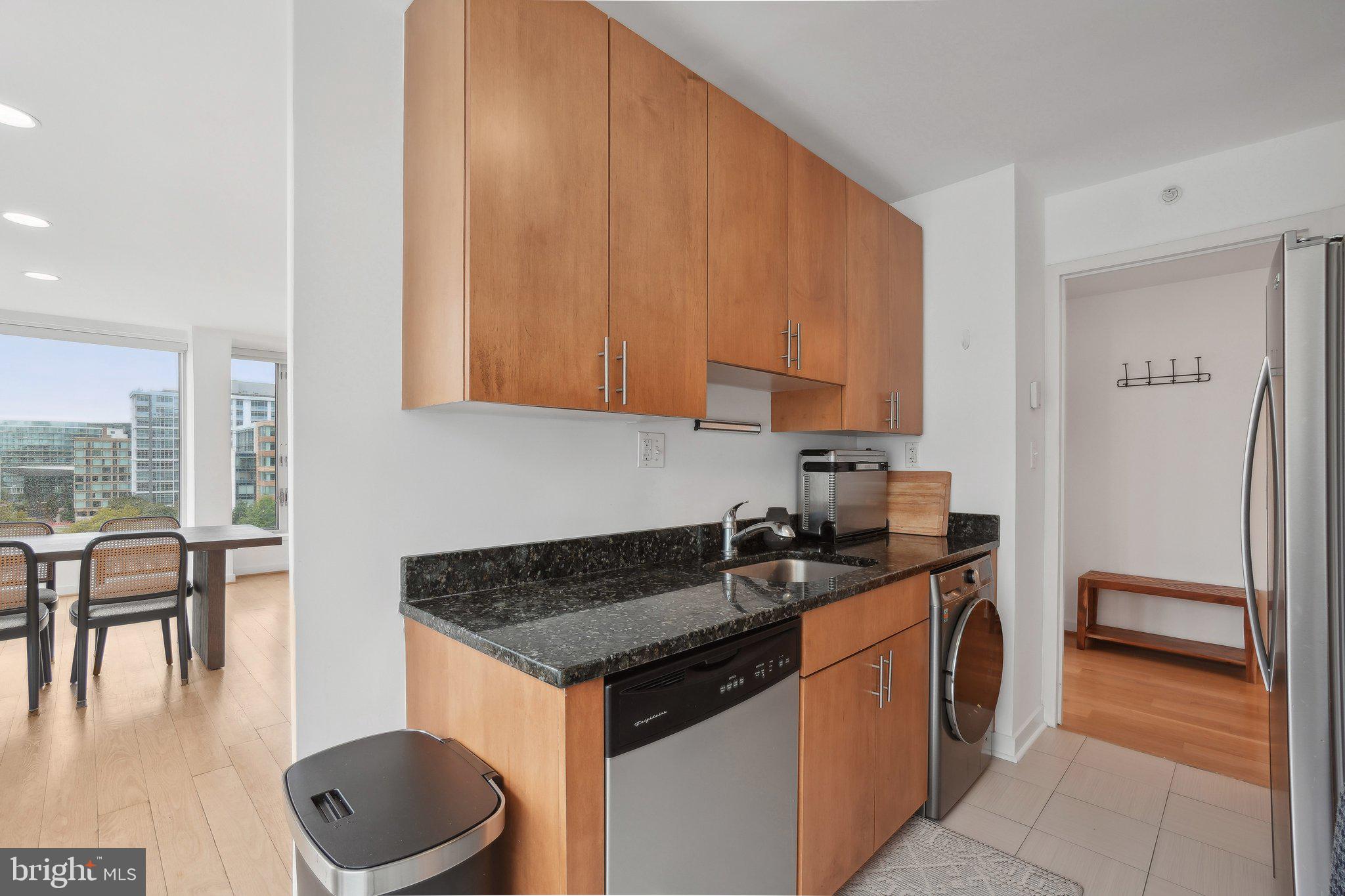 1101 3rd Street Southwest, Unit 706 Washington, DC 20024 - Photo 15 of 26 a kitchen with a sink a stove and cabinets