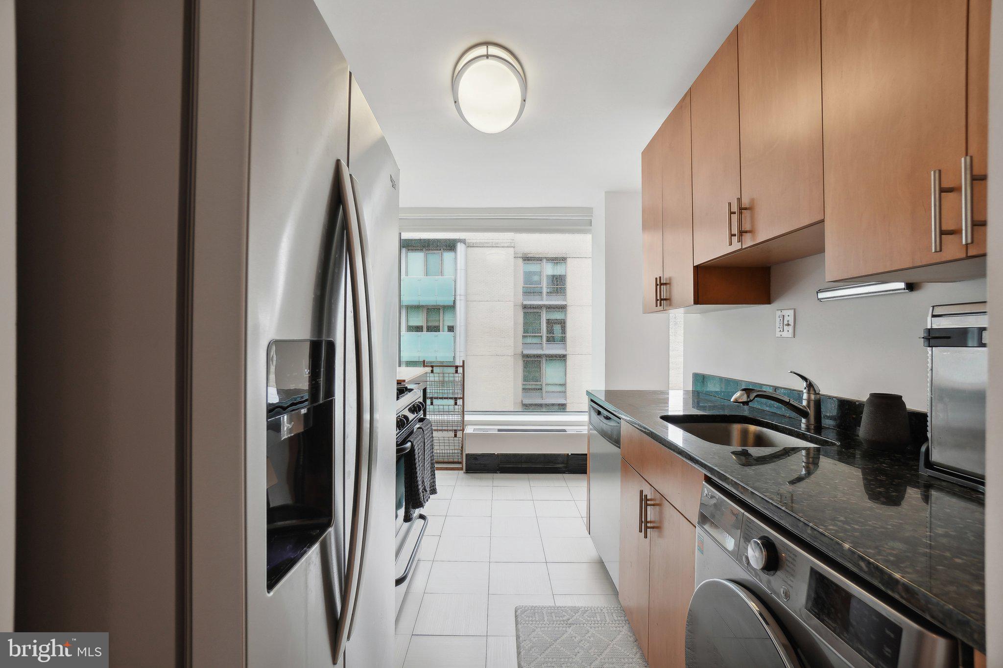 1101 3rd Street Southwest, Unit 706 Washington, DC 20024 - Photo 16 of 26 a kitchen with stainless steel appliances granite countertop a sink stove and refrigerator