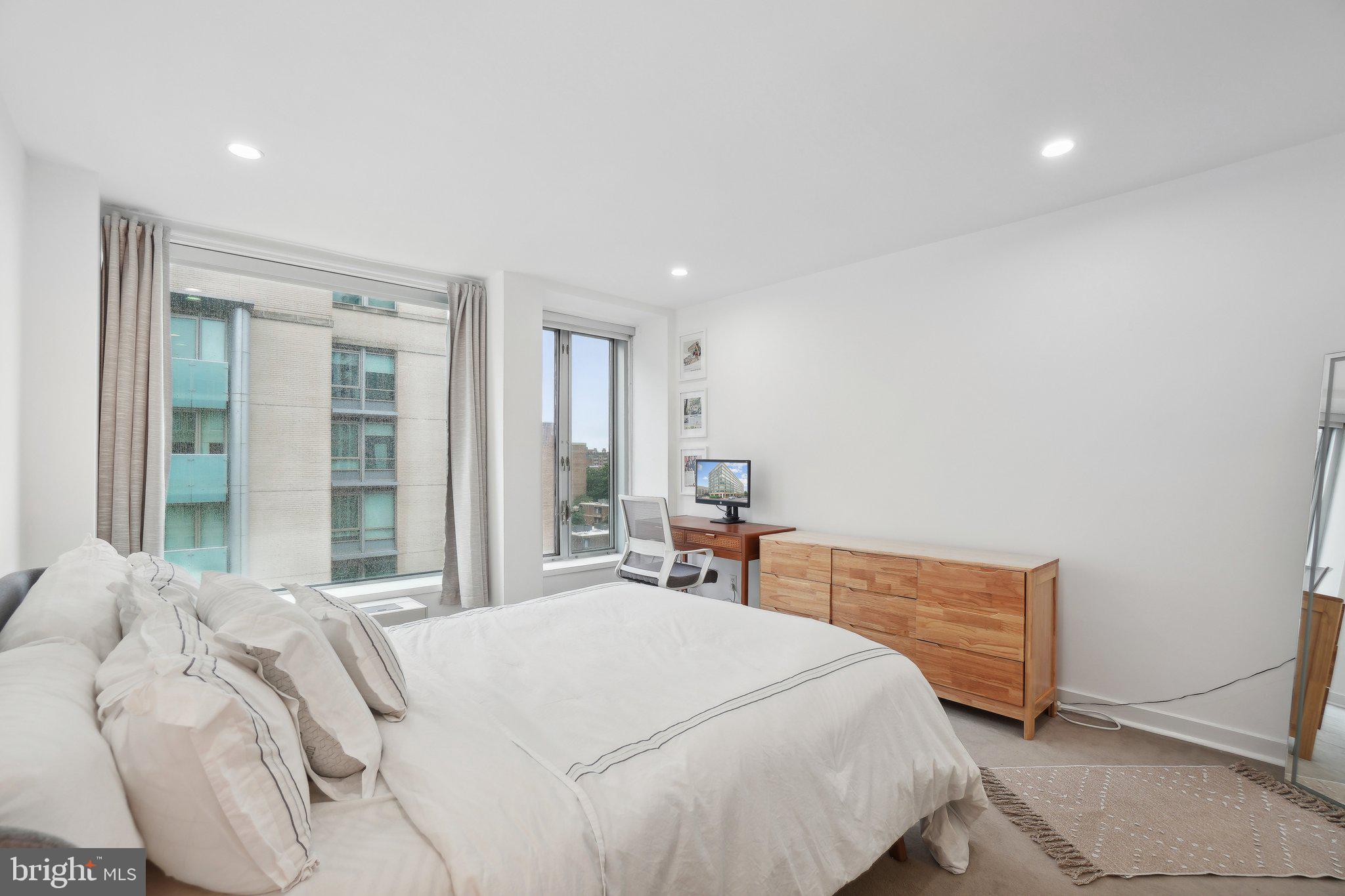 1101 3rd Street Southwest, Unit 706 Washington, DC 20024 - Photo 17 of 26 a bedroom with a bed and a large window